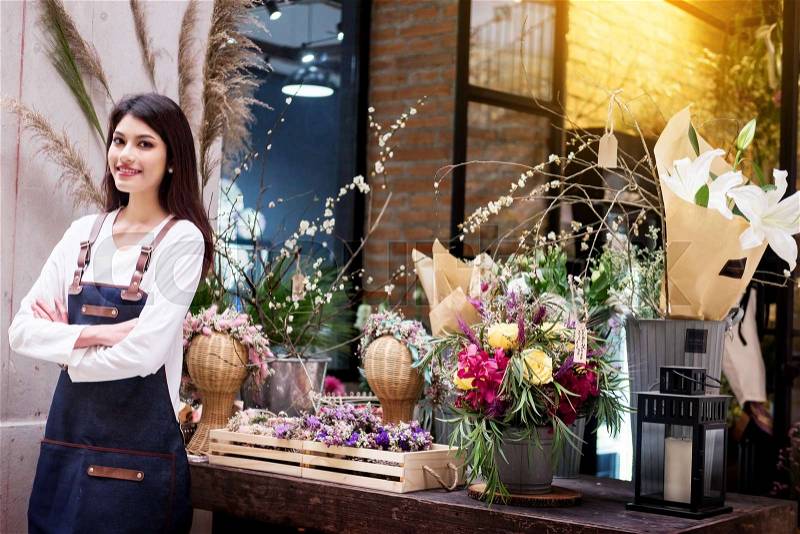 Beautiful Florist self-employed in flower shop, Small business, stock photo