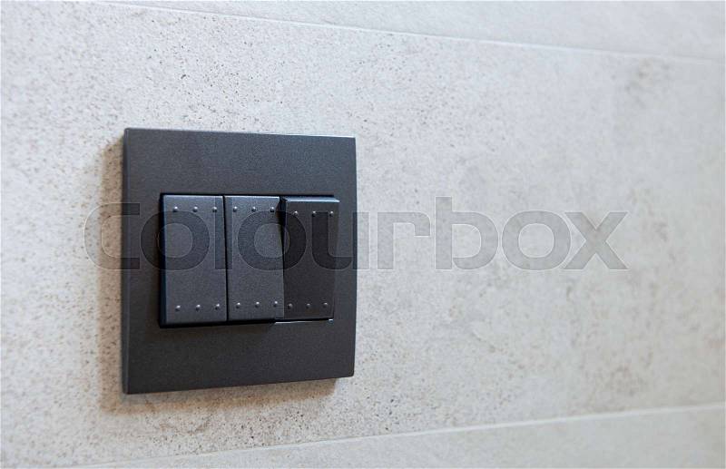 Black light switch on the wall, stock photo
