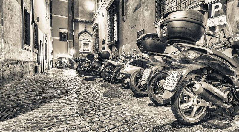 ROME - MAY 20, 2014: Motorbikes parked along city streets. Motorbike is one of the best way to visit the city, stock photo