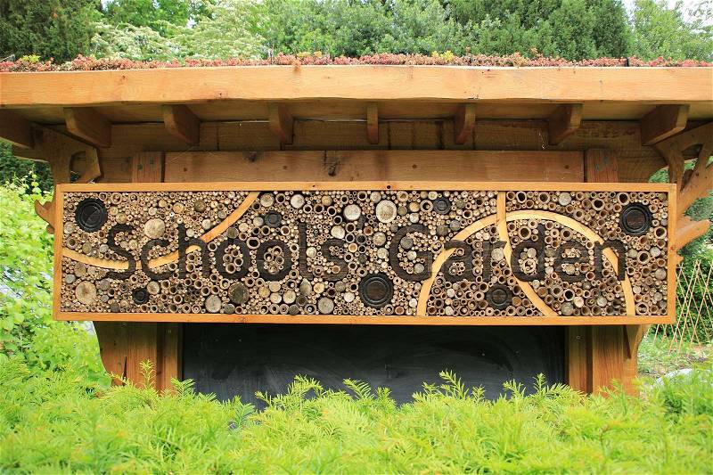 Xerophyte on the roof of the bee house with the words, Schools Garden in the Cambridge University Botanic Garden in the city Cambridge in England on a sunny day in spring, stock photo