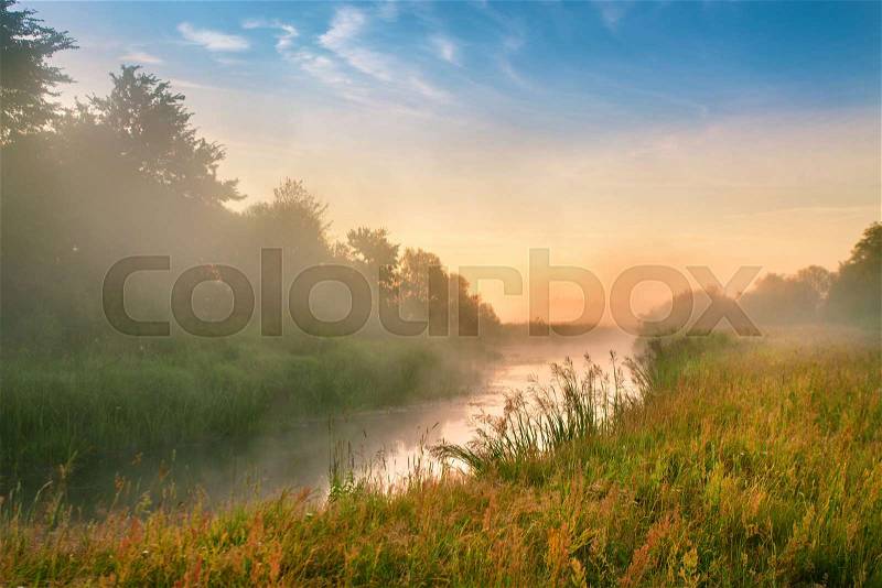 Foggy river in the morning. Summer misty sunrise on the river. Misty morning panorama, stock photo
