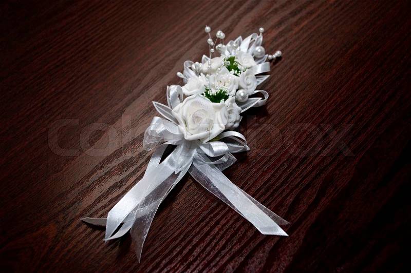 White wedding bouquet on brown desk background, stock photo