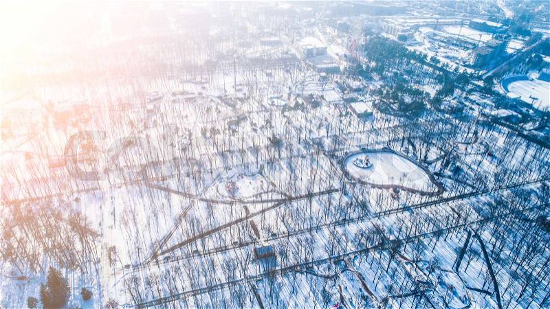 Top view of central city park during winter with snow. Aerial view of winter urban park with no people, stock photo