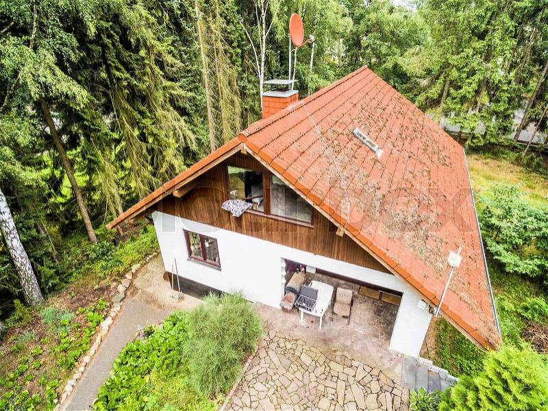 House for a family in the forest, aerial view with drone, stock photo