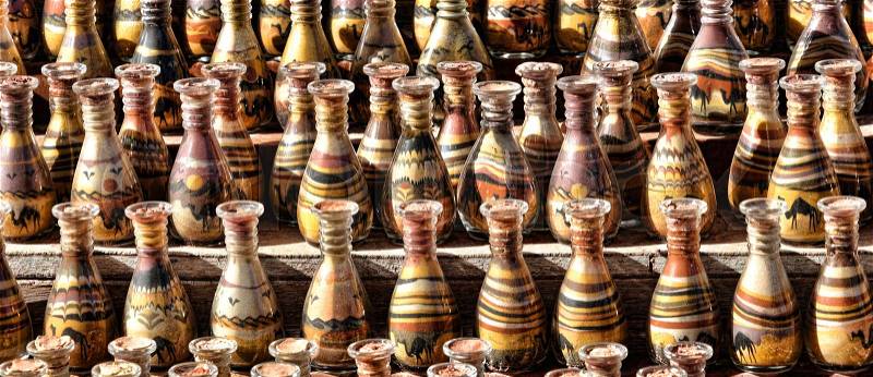 Bedouin stall with sand painting in bottles with layered coloured sand in the rock town and necropolis of Petra , jordan, middle east, stock photo