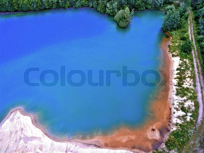 Highly worked image of a gravel lake in which sand is mined for the construction industry, Germany, stock photo