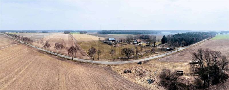 Composite panorama of aerial photos at the edge of a field with a farm in the background, Germany, stock photo