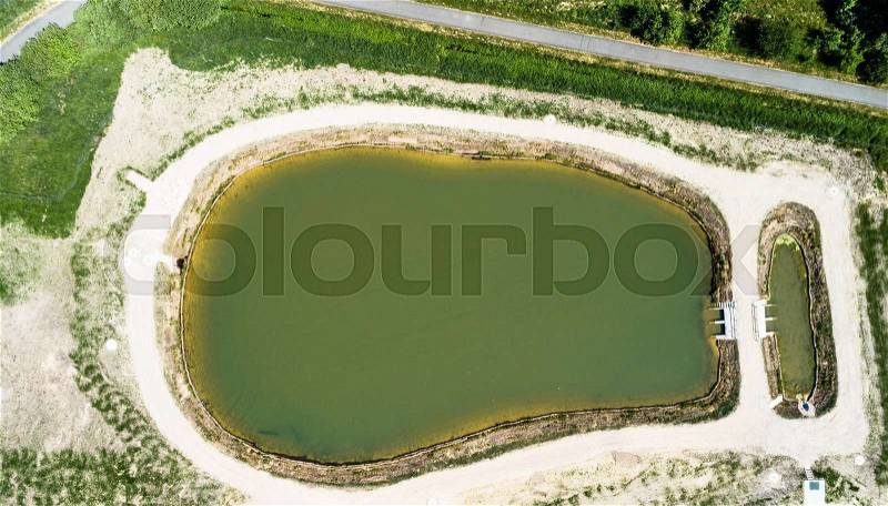 Aerial view of a rain retention basin at the edge of a new development, taken vertically, Germany, stock photo