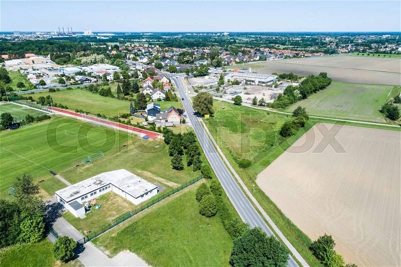Aerial view of the clubhouse of a regional football club on the outskirts of the city next to a big street, football field in the background, near Wolfsburg, stock photo