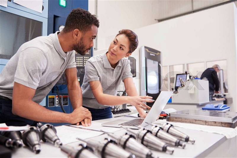 Two Engineers Using CAD Programming Software On Laptop, stock photo