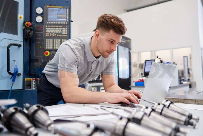 Male Engineer Using CAD Programming Software On Laptop, stock photo