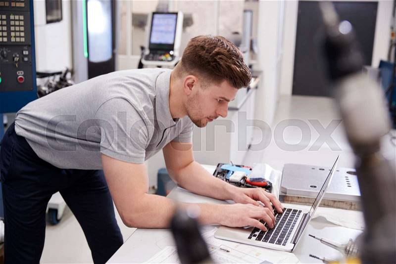 Male Engineer Using CAD Programming Software On Laptop, stock photo