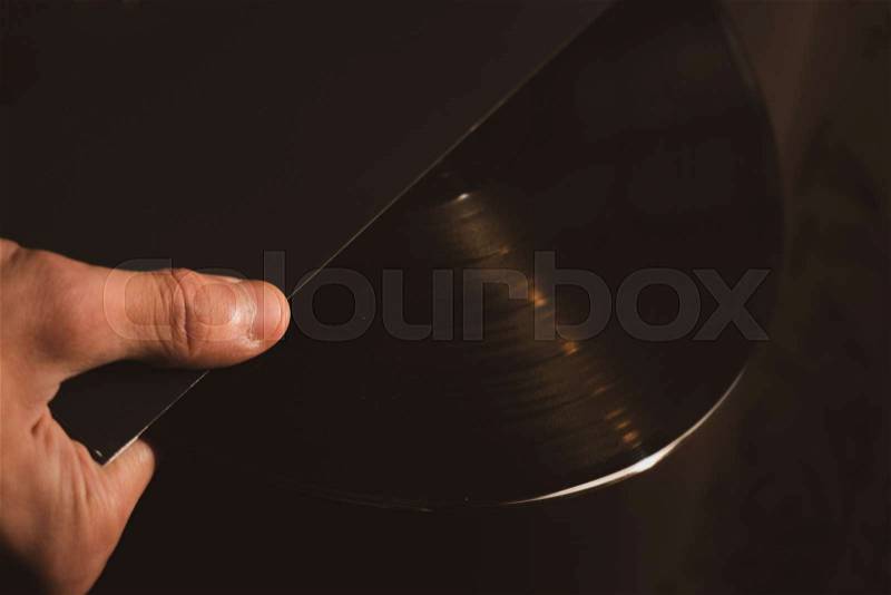 Vintage vinyl disk in hands close up, stock photo