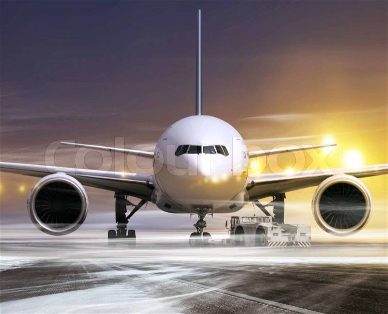 White plane in airport at non-flying weather, blowing snow, stock photo