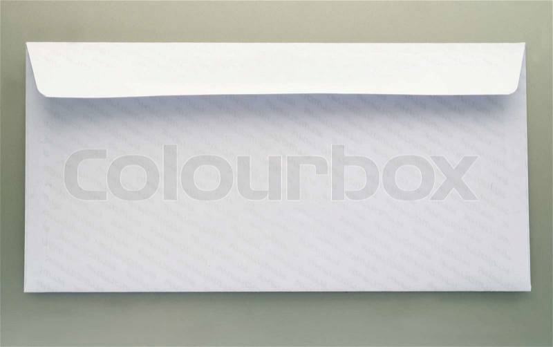 White mailing envelope with a gray background, stock photo