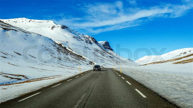 A long straight road and cars in winter. , stock photo