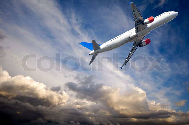 Plane and dark thunder couds, stock photo