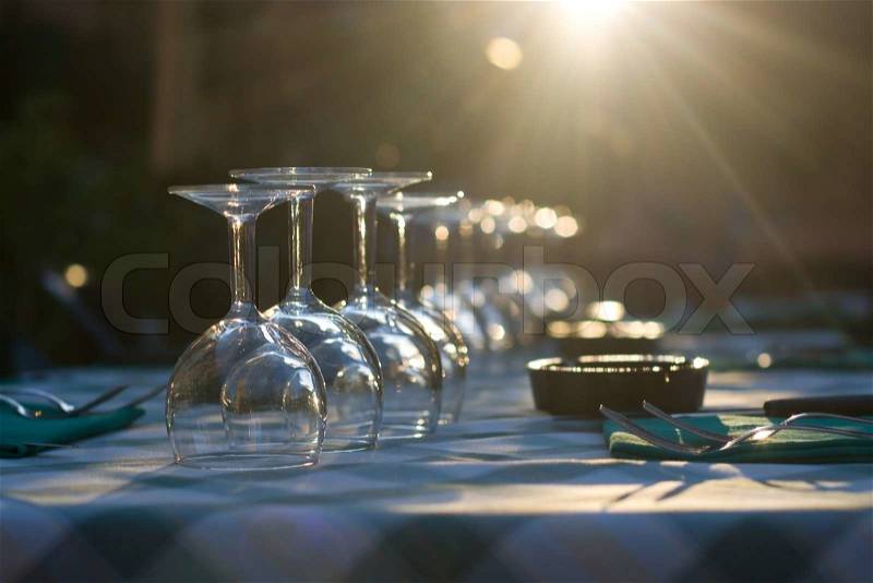 Glasses on a table at restaurant with sunlights coming throw it, stock photo