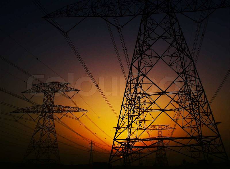 Electricity Pylon over dark sunset sky, environmental damage concept, stock photo