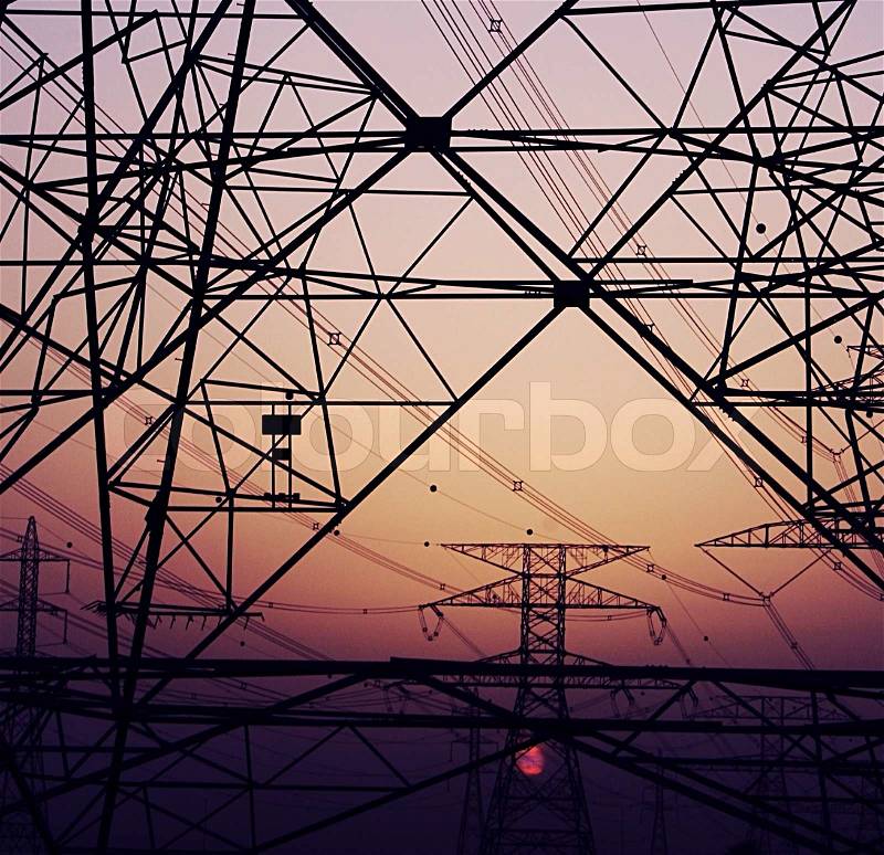 Abstract background of electricity pylons over purple sunset, conceptual image of invironmental damage and pollution of nature, stock photo