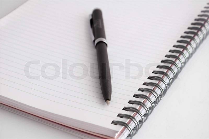 Pen and notebook on white background, stock photo