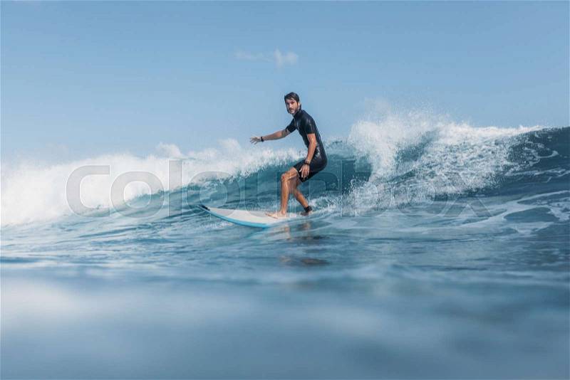 Sports man surfing wave on surf board in ocean , stock photo