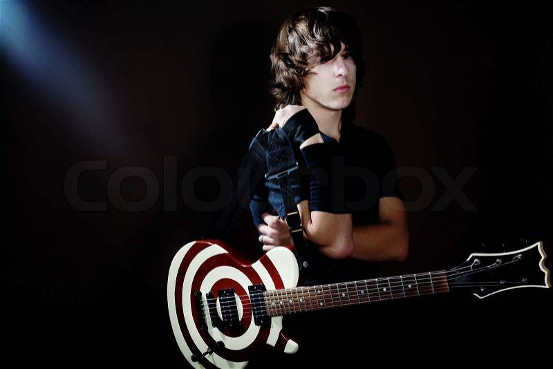 An image of a young man with striped guitar, stock photo