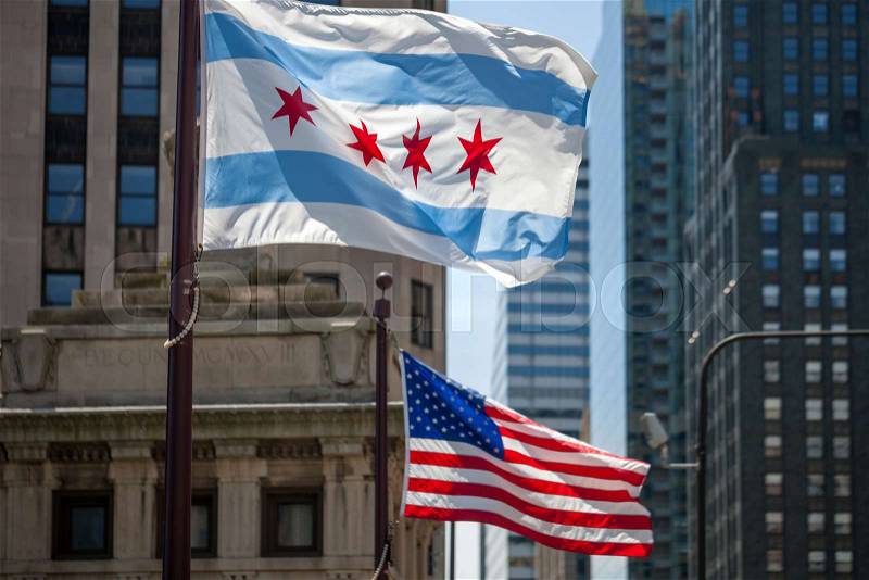 Waving flags of the city of Chicago and of the United States of America in downtown Chicago, stock photo