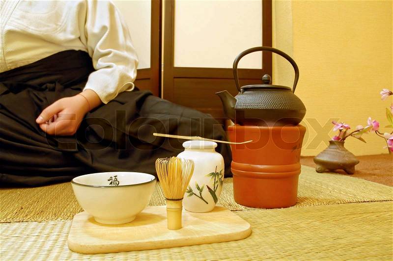 Tools used for Japanese tea ceremony chado A brush made of bamboo and a teacup with green tea called matcha on wooden tray And tea master in kimono, stock photo