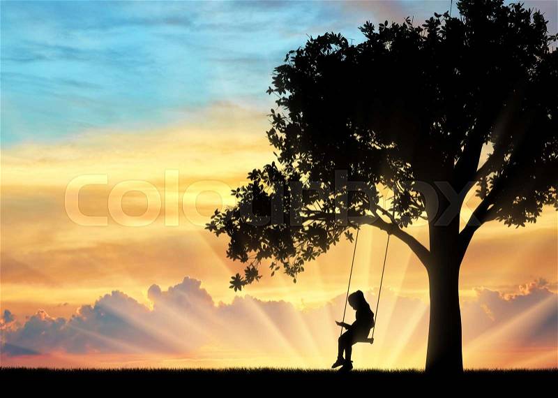 Silhouette of little girl reading book sitting on swing. Conceptual image of childhood, stock photo