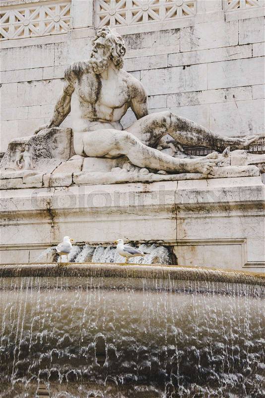Close-up shot of ancient fountains statue element with male figure sculpture, Rome, Italy, stock photo