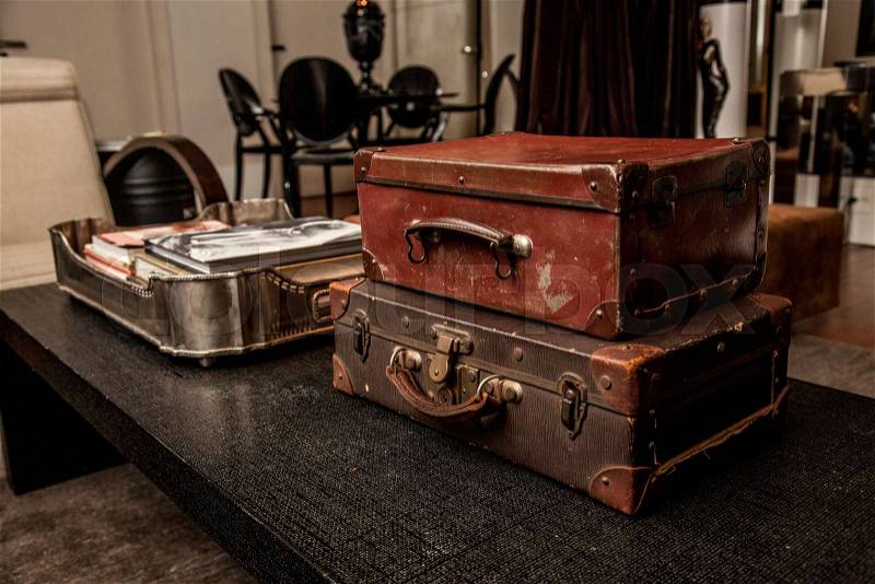 Vintage Pile Ancient Suitcases Form of Tower Design Concept Travel Luggage on a vintage living room, stock photo