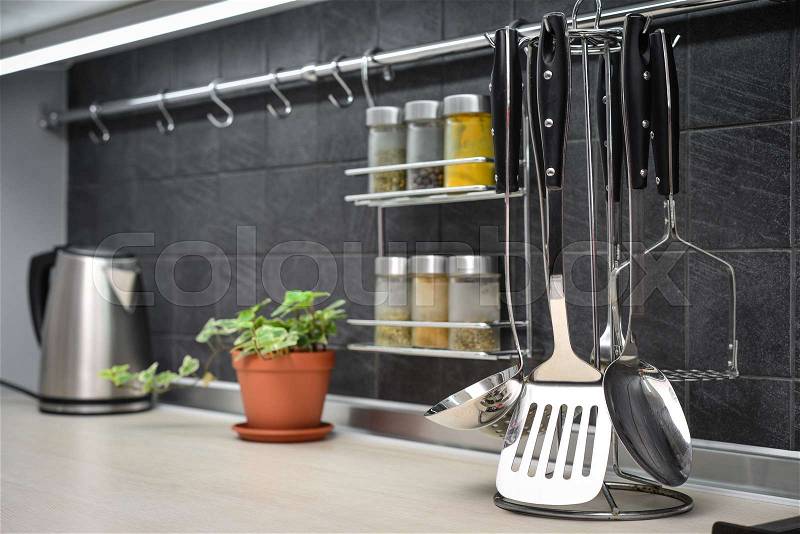 Kitchen utensils on work top in modern kitchen closeup, stock photo