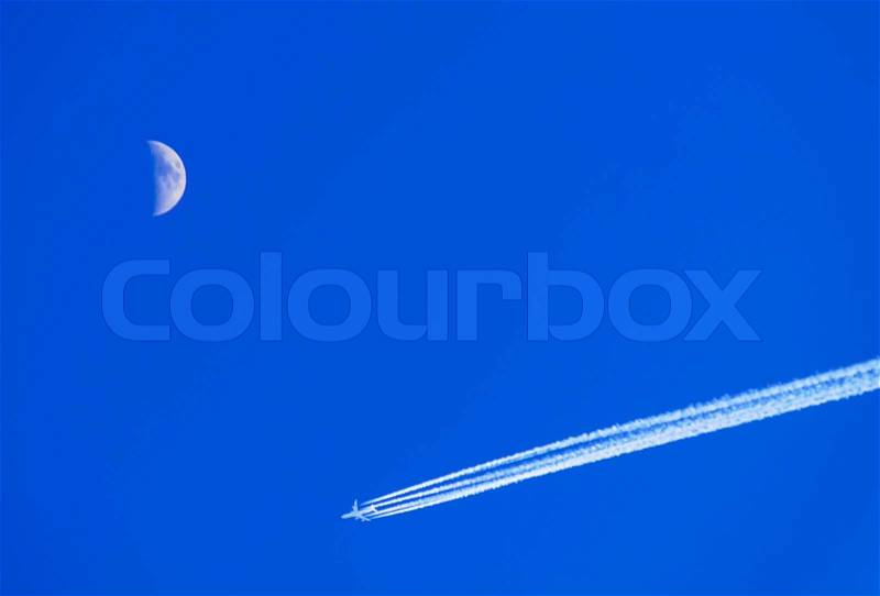 Blue Sky, Moon and Jet Aircraft with Condensation Vapor Trail, stock photo