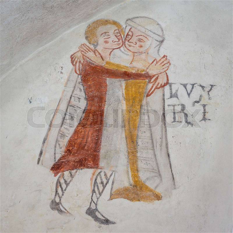 Lust, one of the mortal sins. Man and woman embracing, an ancient gothic mural in Kirkerup public church, Denmark, July 3, 2018,, stock photo