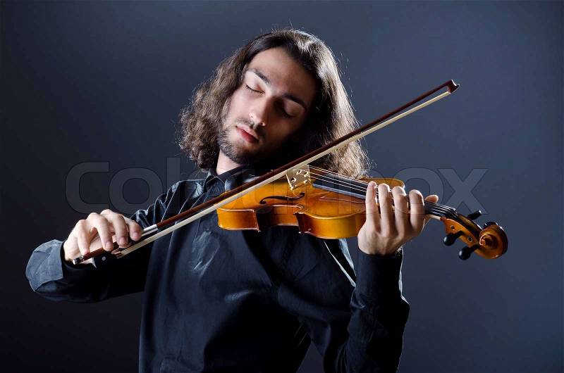 Young violin player playing, stock photo