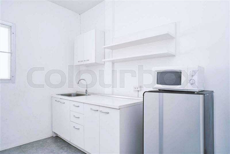 Modern living concept, White clean kitchen room with built-in furniture decoration ideas with water sink, storage, cabinet, shelf, refrigerator and microwave mock-up, stock photo