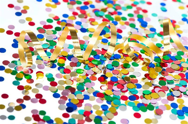 Colorful confetti background with golden streamer on white background, stock photo