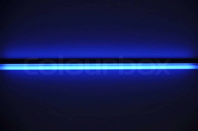 Fluorescent tube shining ray on dark blue background, stock photo