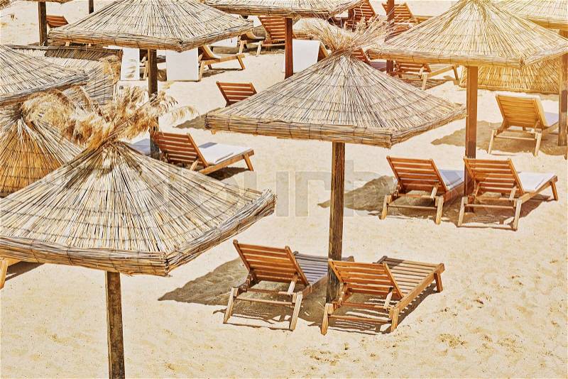 Beach Umbrellas and Lounge Chairs on the Sea Coast, stock photo