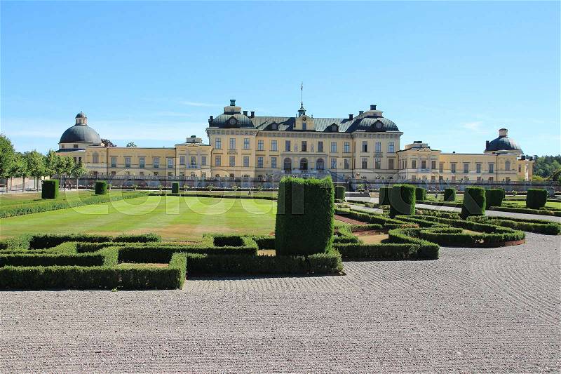 Blue sky with clouds, the garden in style of baroque and in the distance Drottningholm palace in Sweden in the summer, stock photo