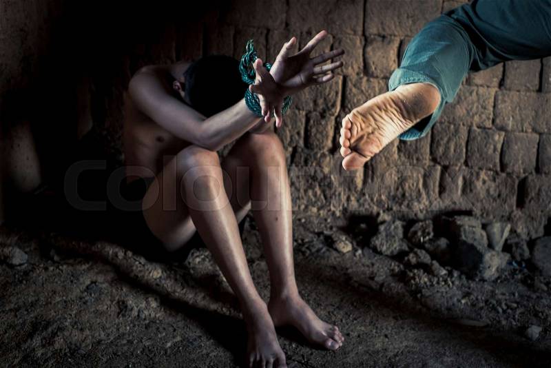 Violent criminals with children. Man Kicking victims in abandoned clay building. concept for stop abusing violence.kidnapping, A fearful child, Human Rights, stock photo