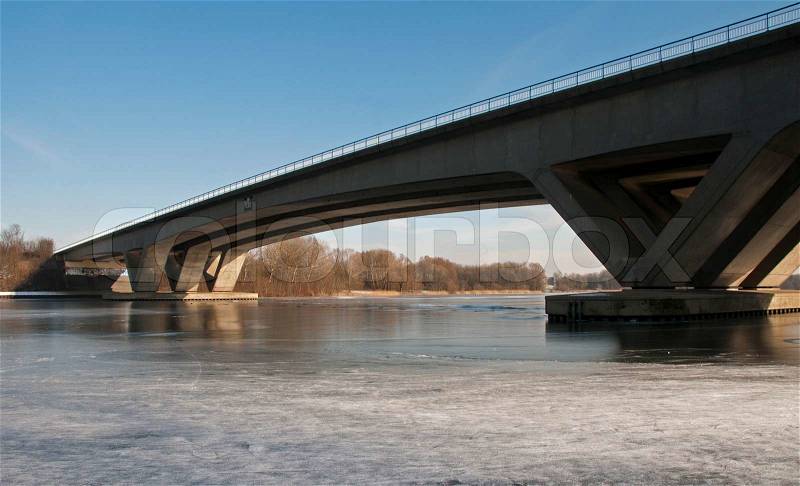 Bridge crossing the river with ice in the winter, stock photo