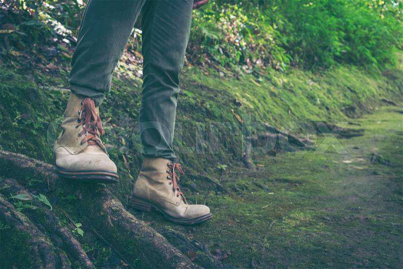 Hiking concept - close up of male legs on forest road, stock photo