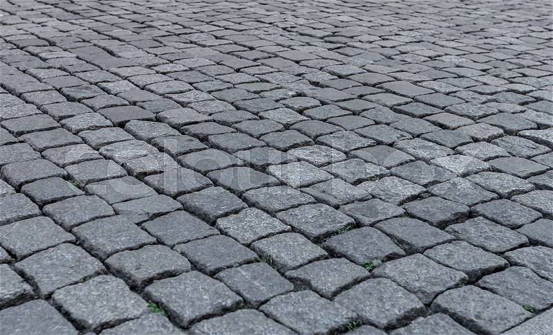 Old road paved with stone. The texture is clearly visible. Close-up, stock photo