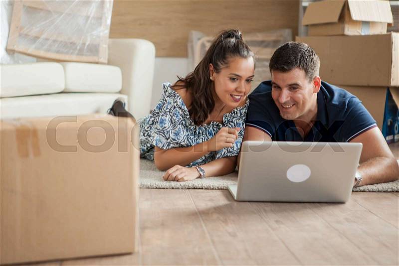 Wife showing to her husband the new tv they are gonna buy For their new house, stock photo