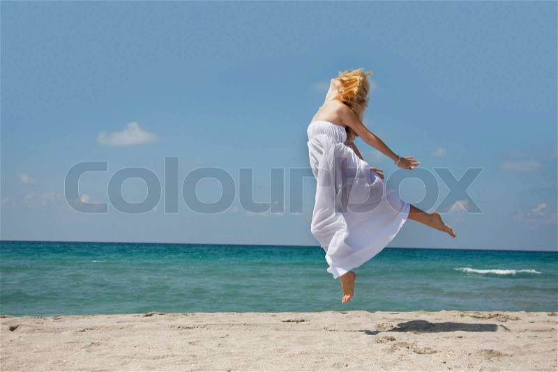 Young woman flying on sea background, stock photo