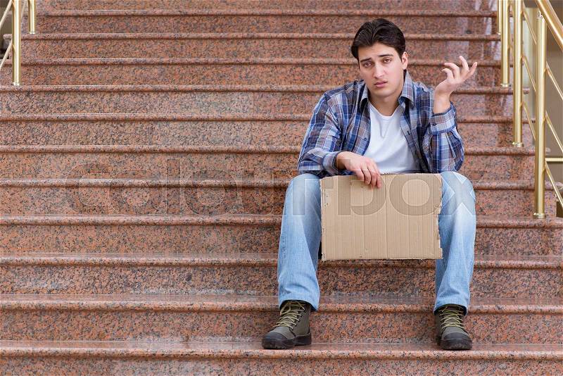 Young man begging money on the street, stock photo