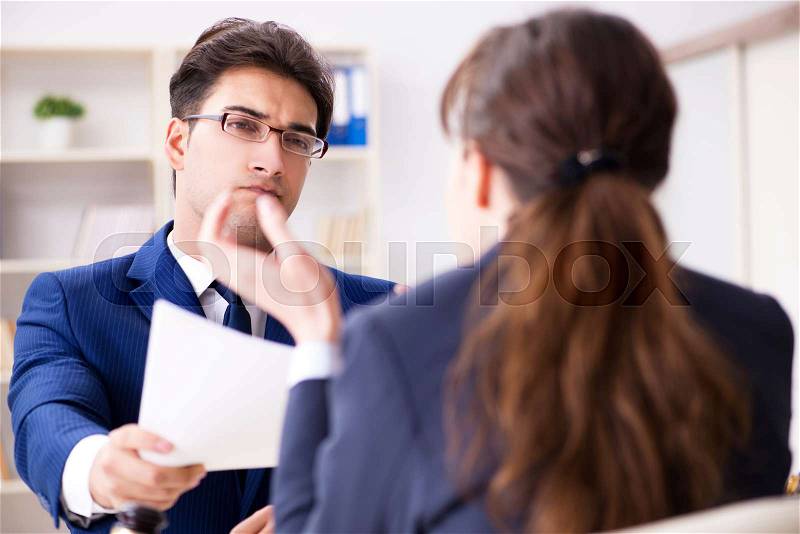 Lawyer talking to his client in office, stock photo