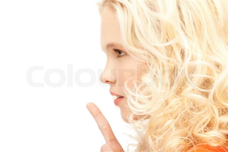 Bright picture of young woman with finger on lips, stock photo